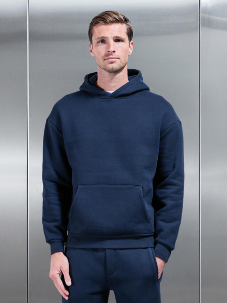 RELAXEDFITHOODIEINNAVY1_3384908a-4d02-4a3e-abb2-e9649a7be91f_600x600.jpg